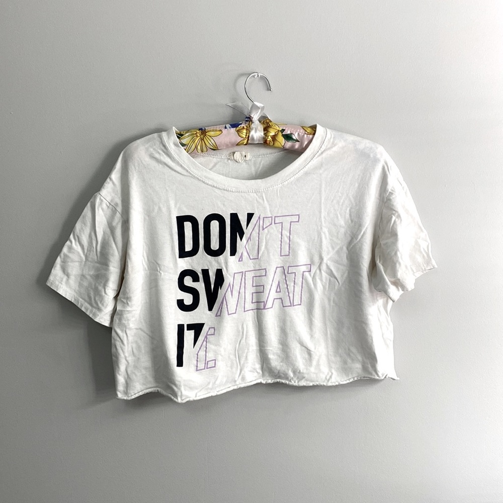 White crop top with purple and black logo